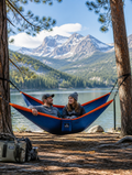 Double hammock set up between trees in a sunny outdoor space