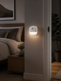 Motion sensor night light magnetically attached to modern bedroom wall