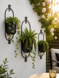 Iron art hanging flower pots on garden wall