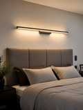 SlimGlow Linear LED Wall Sconce above headboard in modern bedroom