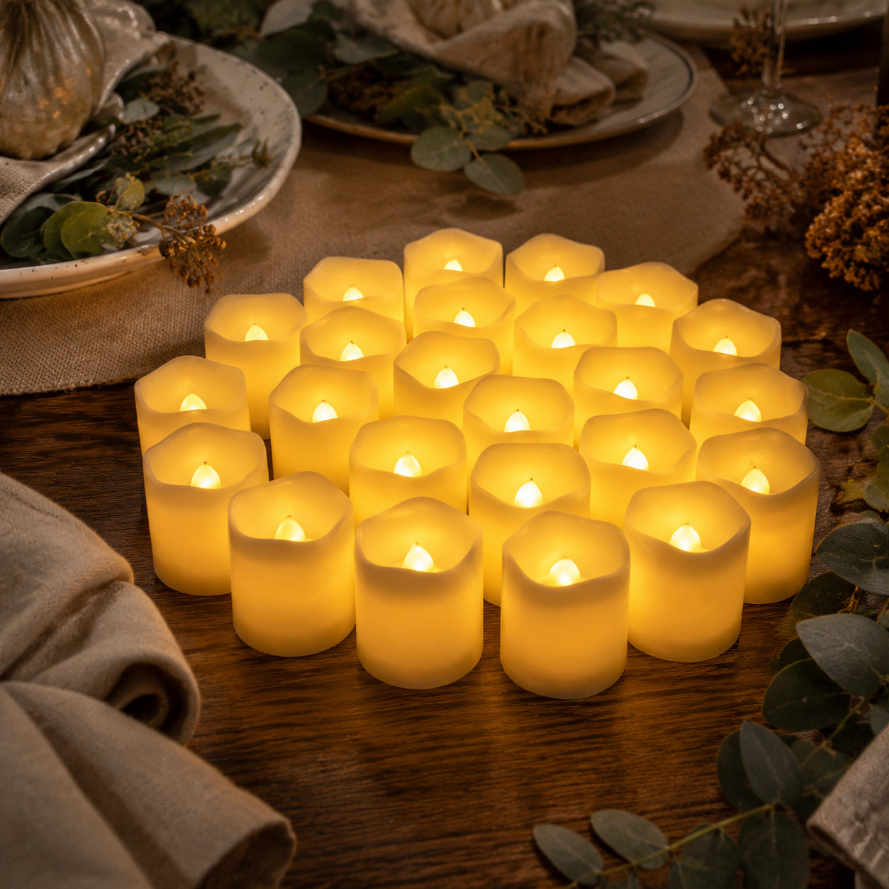 Twenty-four warm flameless LED tea lights styled on an autumn dining table