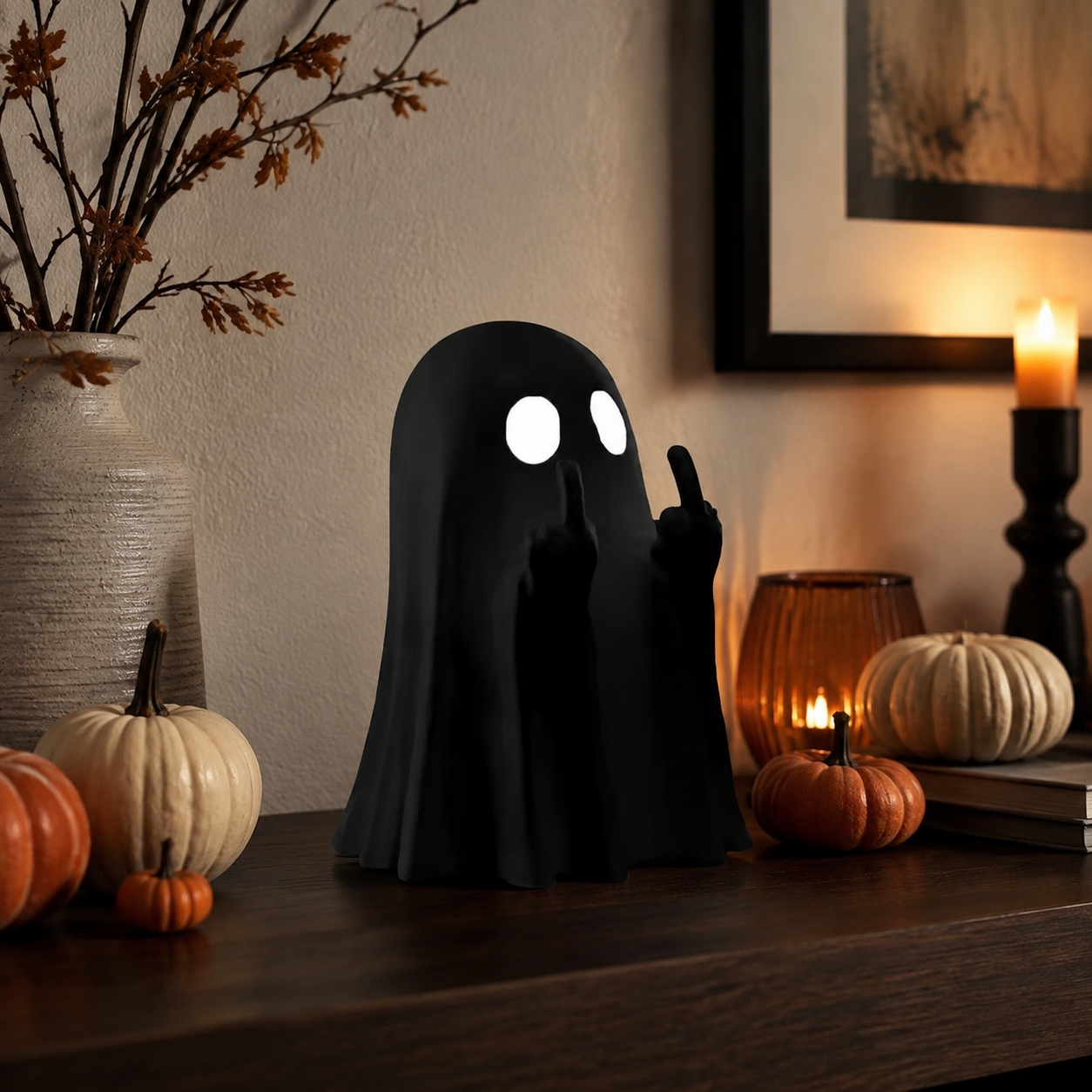 Black Cheeky Ghost figurine styled on a warm Halloween console table