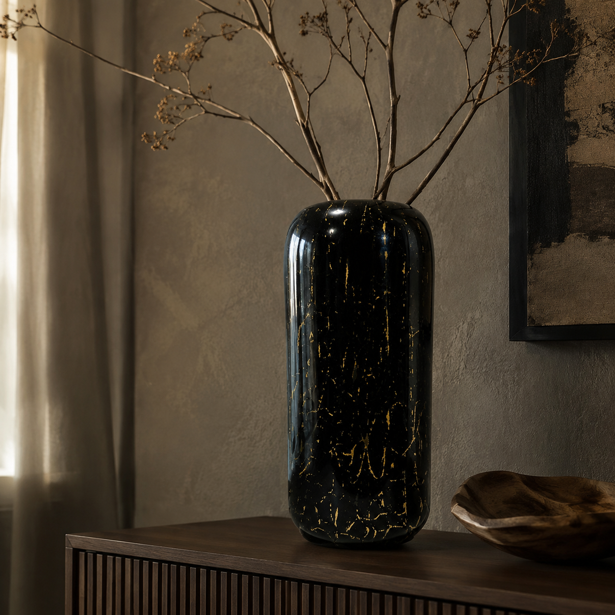 Tall black and gold glass vase in an elegant interior