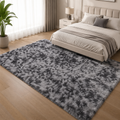 Dark grey tie-dye plush area rug in a modern bedroom
