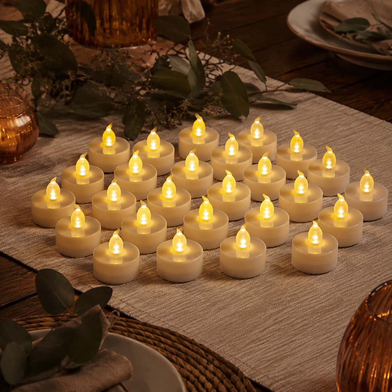 Twenty-four warm white flameless tea lights styled on an autumn dining table