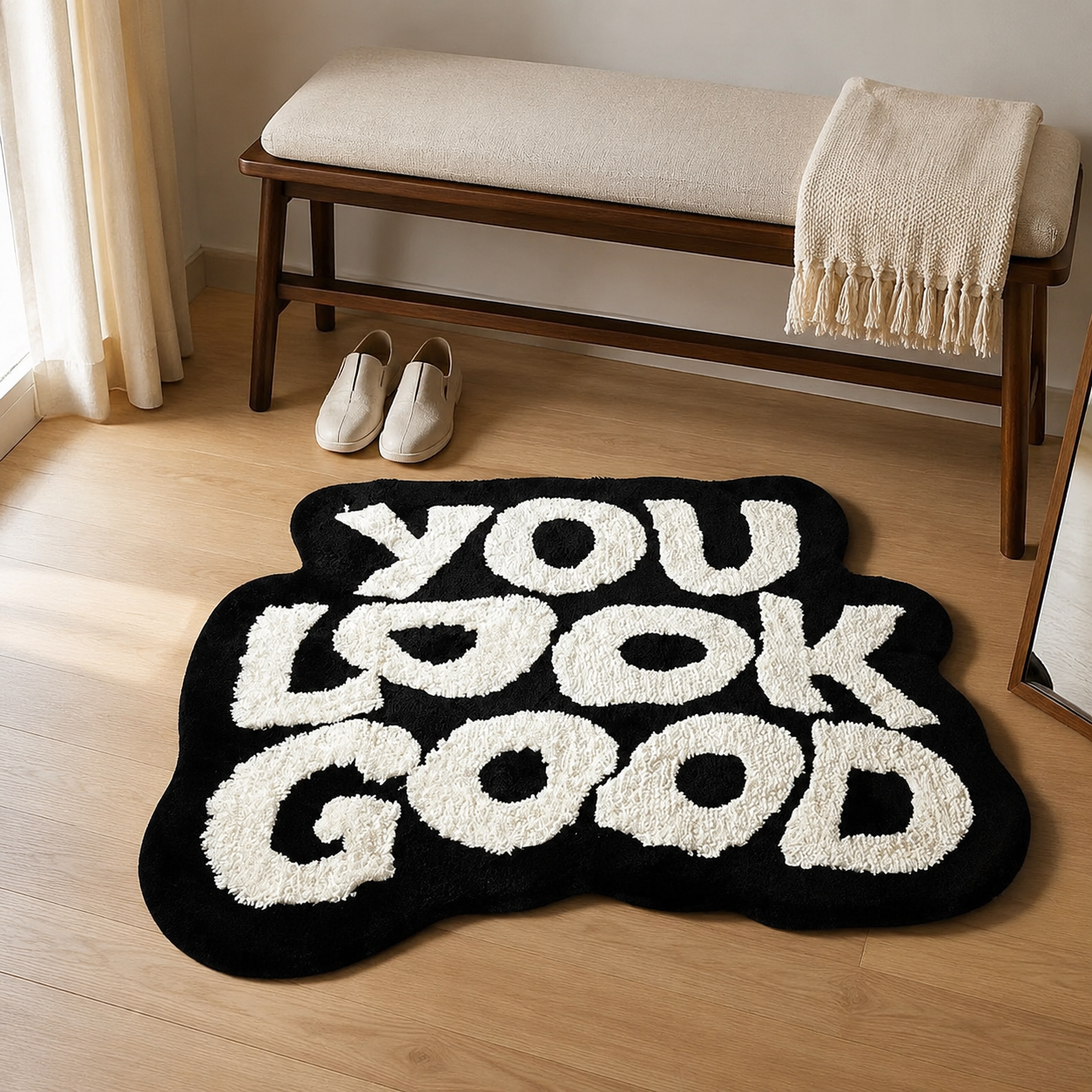 Black and white YOU LOOK GOOD tufted rug styled in a dressing area
